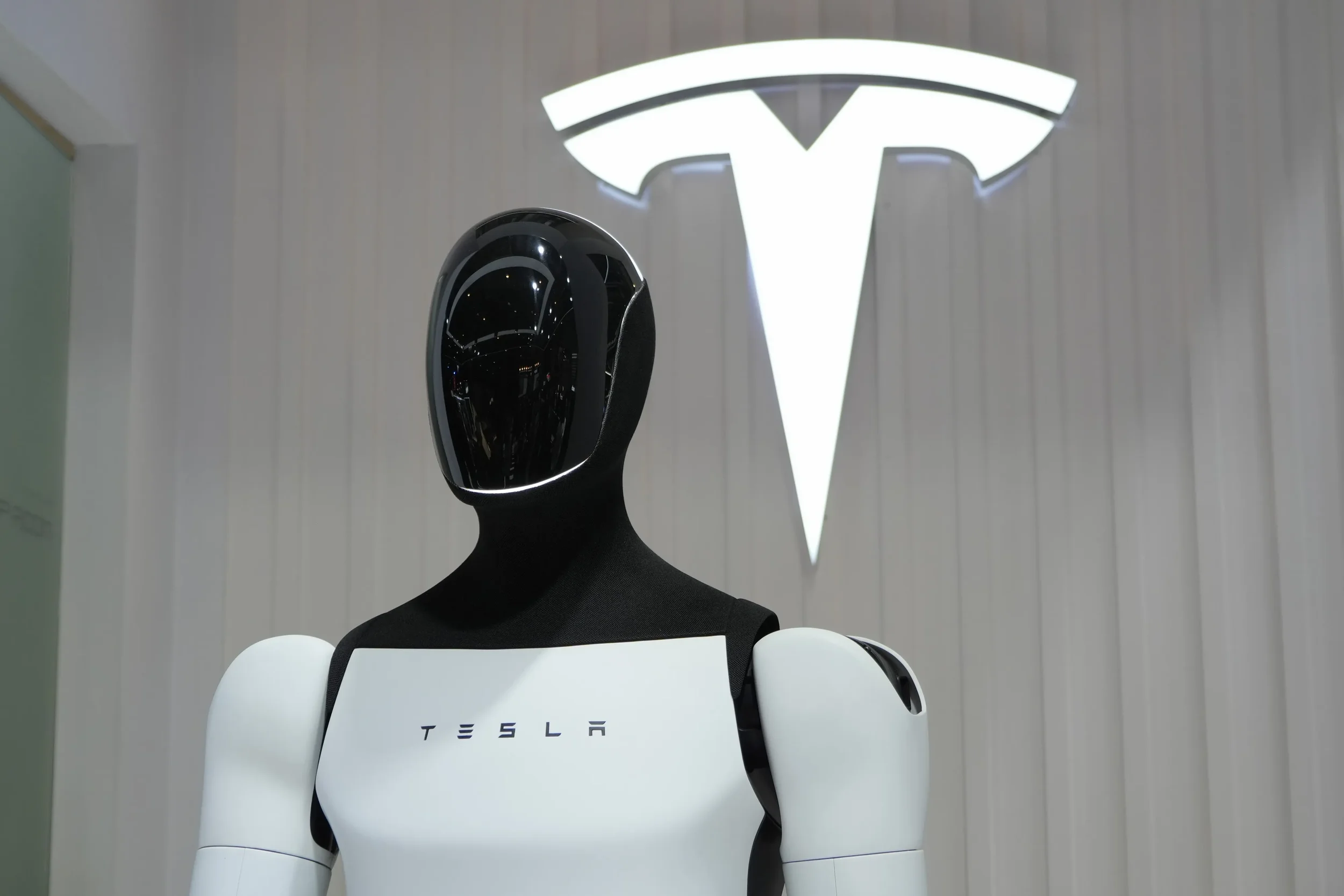 Tesla Optimus robots on a factory line illustrating the humanoid labor market opportunity