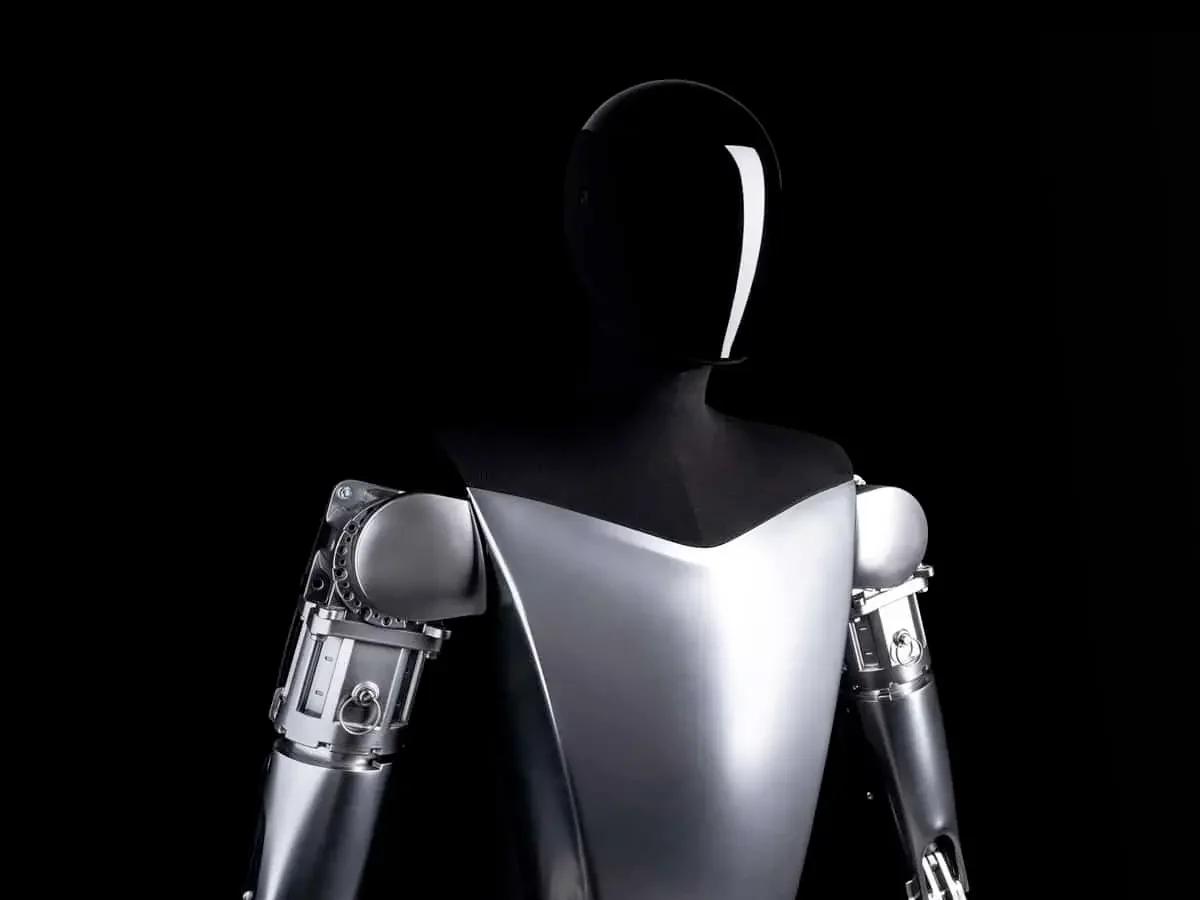 Optimus humanoid robots on a Tesla assembly line illustrating the coming humanoid robots economy
