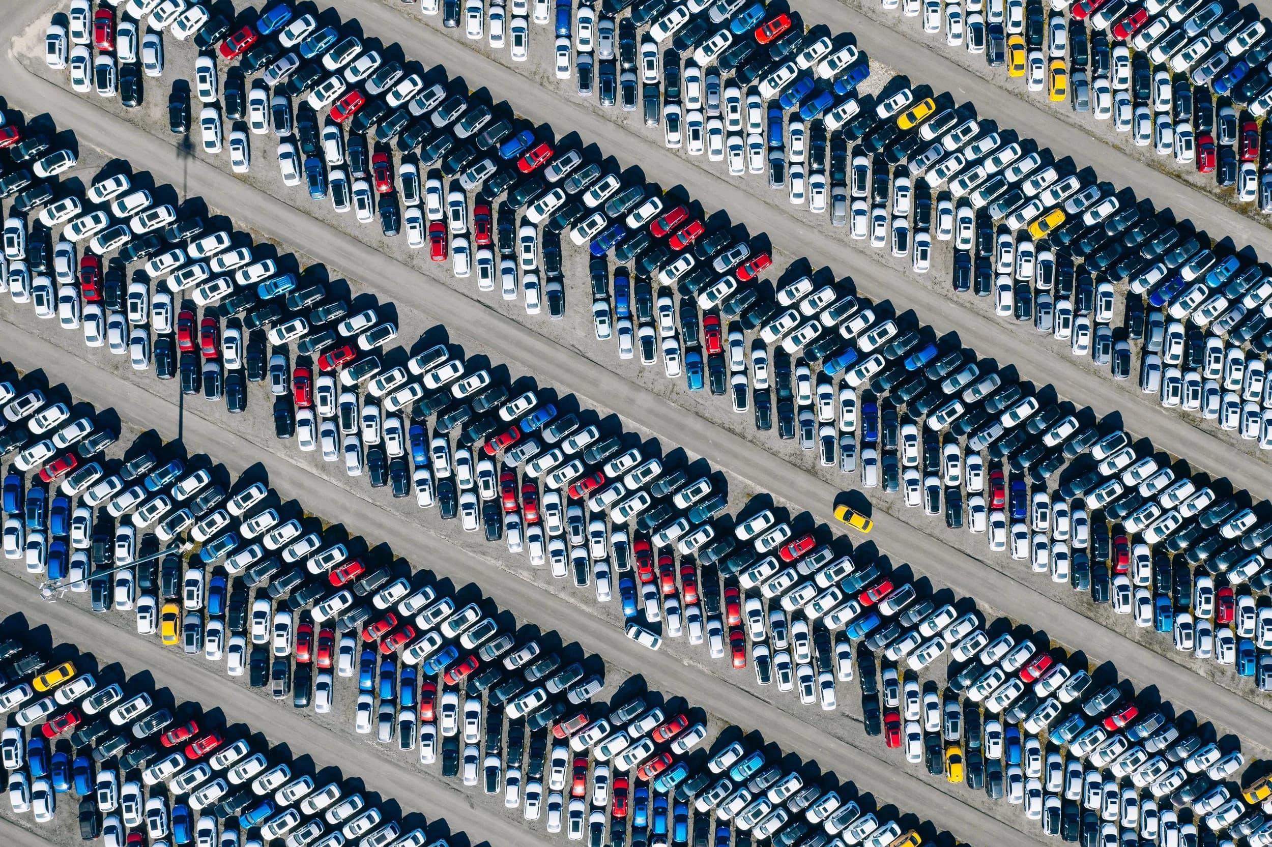 Depreciating used car values next to a robotaxi, illustrating car depreciation from autonomy