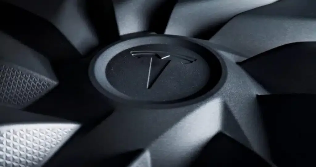 Tesla product teasers montage: affordable EV, Roadster, and Optimus robot in a kung fu pose