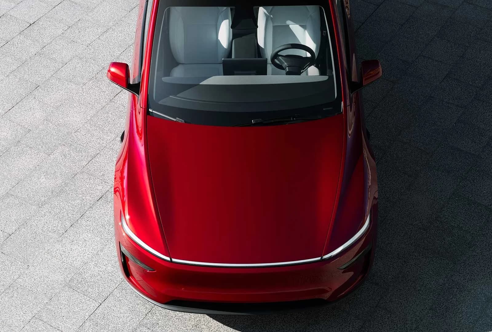 Tesla FSD v14 driverless vehicle navigating a city street as part of a robotaxi network