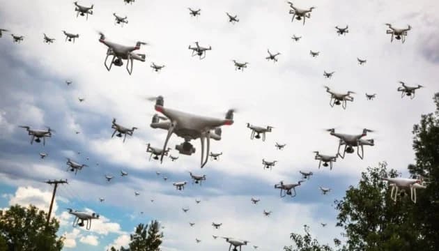 Swarm of autonomous military drones over a battlefield illustrating ai drone warfare and future combat