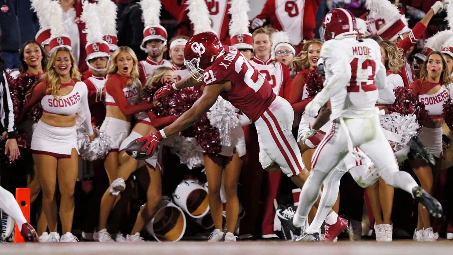 College football player holding cash, illustrating NIL college football deals reshaping the sport
