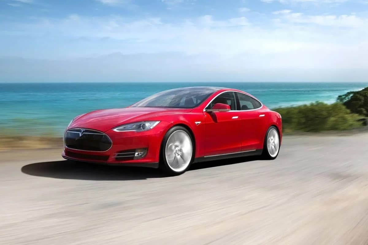 Tesla FSD v14 self-driving car navigating city traffic and yielding to emergency vehicles